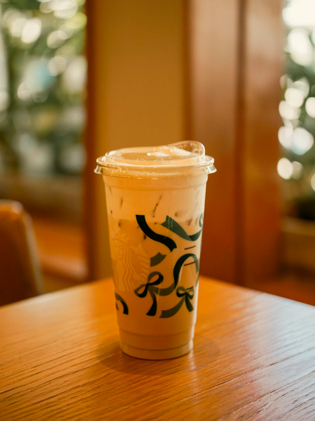 our-story A close-up shot of Starbucks Cambodia’s Creamy Caramel Latte in the holiday cup. The cup features a new Christmas design with green bows, adding a festive touch to the warm, creamy drink and creating a cozy holiday mood.